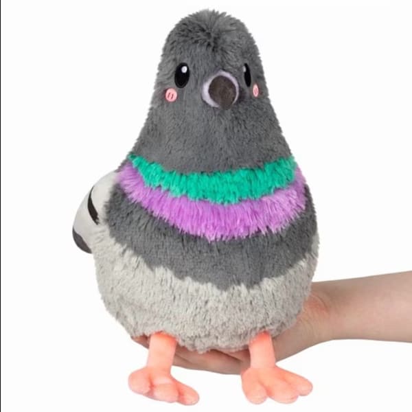 Plush pigeon toy with gray, white, and purple accents held in a hand