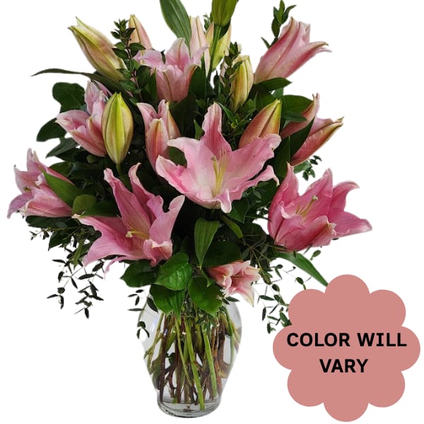 Pink lilies arranged in a clear glass vase