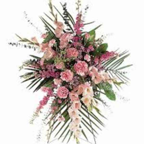 Pink floral spray with long palm fronds and mixed blossoms