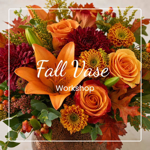 Fall floral arrangement with orange roses, lilies, and mums in a vase