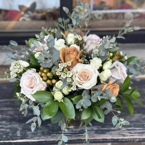 Bouquet of pale roses with eucalyptus and small white filler flowers