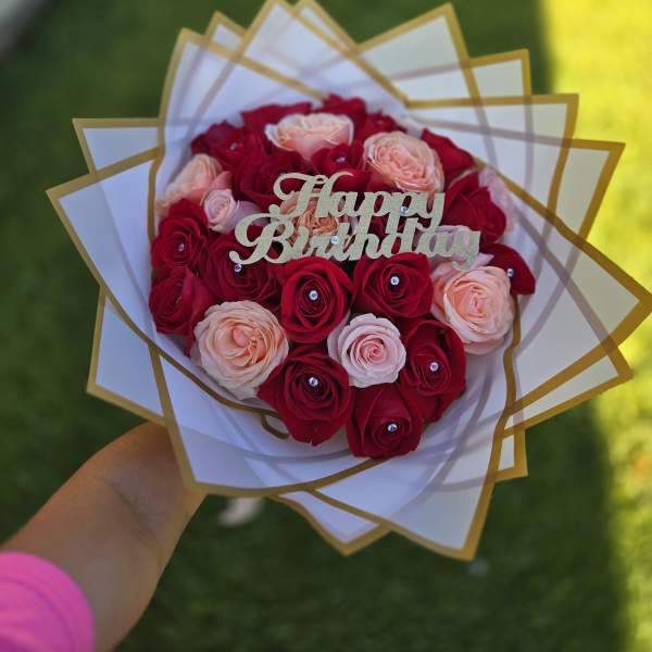 Bouquet of red and blush roses with a Happy Birthday topper