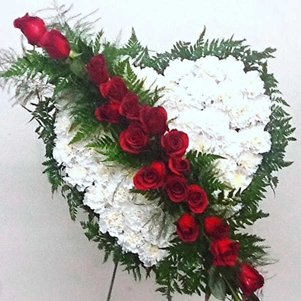 Heart-shaped standing spray of white flowers with red roses