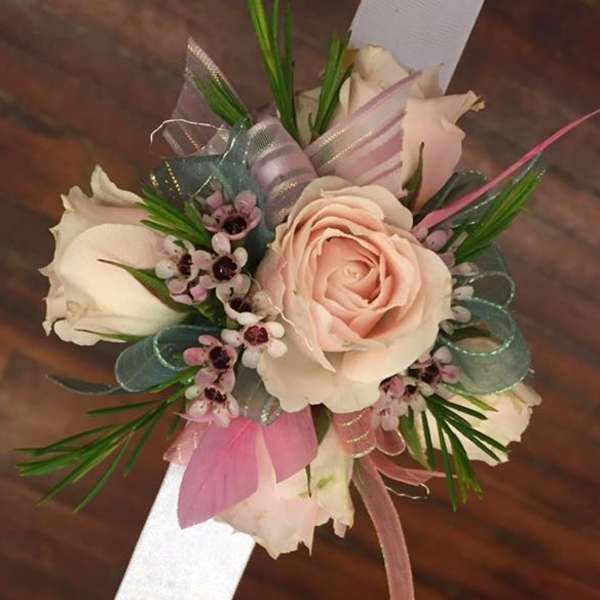 Corsage with pale pink roses and ribbon accents
