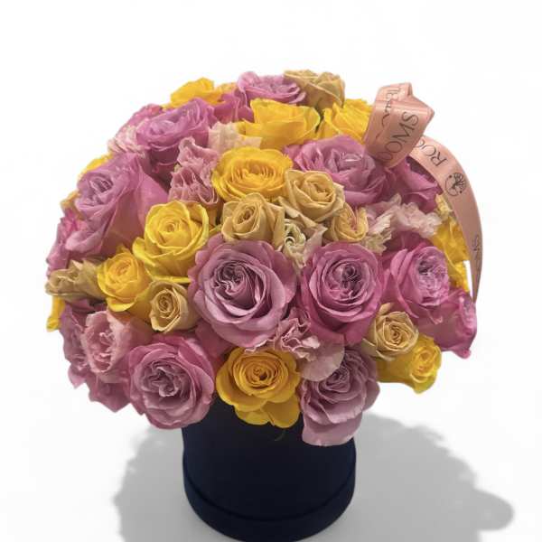 Bouquet of pink and yellow roses in a black hat box