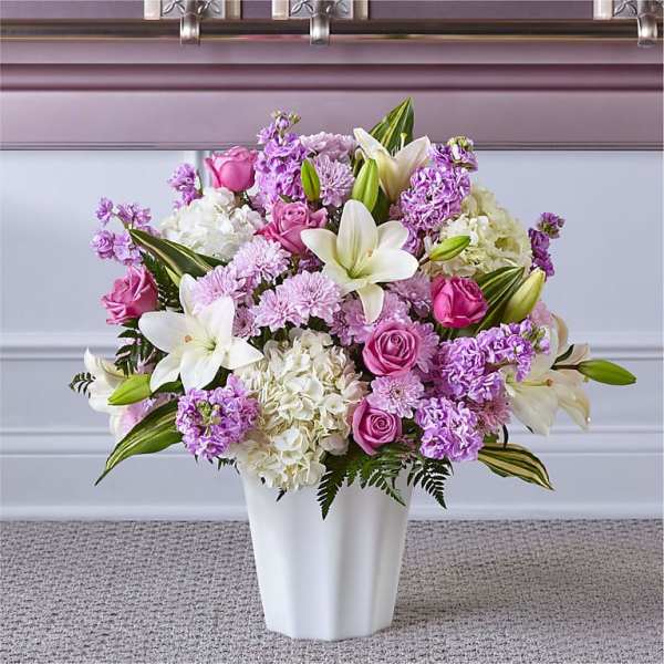 Pink and white flower arrangement in a white vase