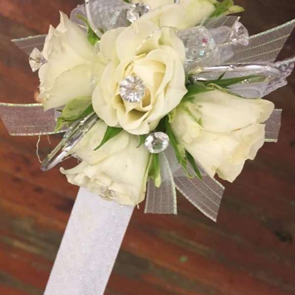 White rose wrist corsage with silver ribbon and clear accents
