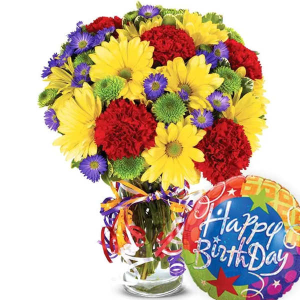 Bouquet of yellow daisies, red carnations, and purple asters in a glass vase with a birthday balloon
