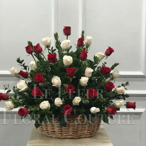 Basket arrangement of red and white roses
