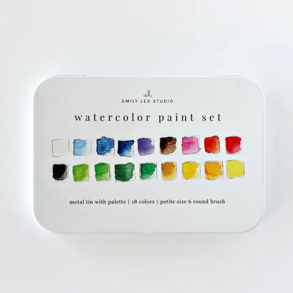 Metal tin of watercolor paint set with multicolored swatches
