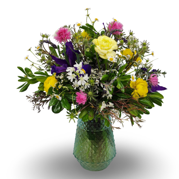 Mixed bouquet of yellow, pink, purple, and white flowers in a green glass vase
