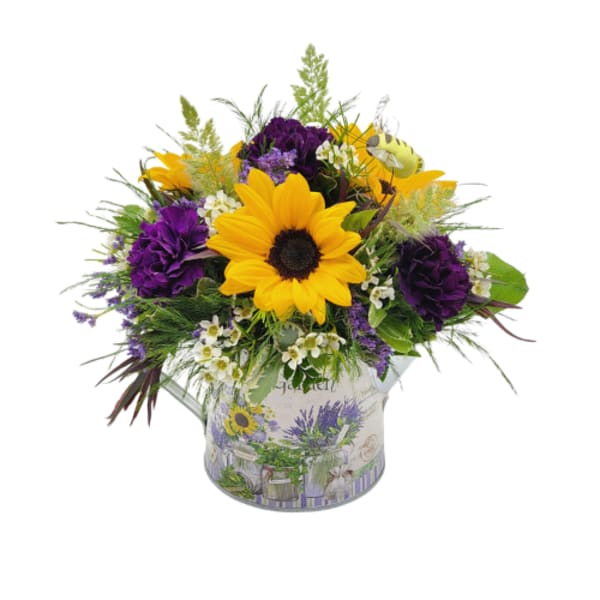 Sunflower and purple flower arrangement in a decorative tin container