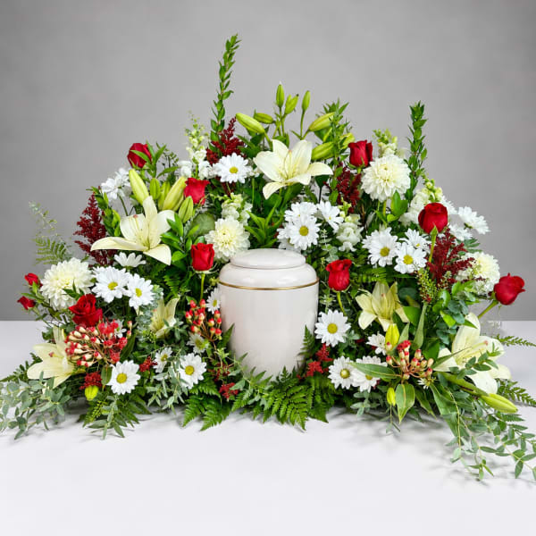 Sympathy floral arrangement with white urn and red roses