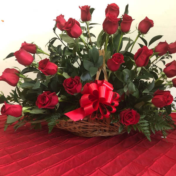 Basket of red roses with a red ribbon bow