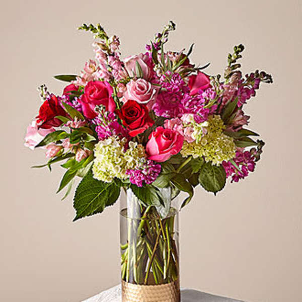 Pink and red rose bouquet in a clear glass vase