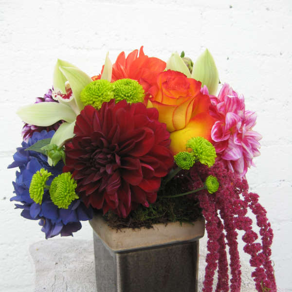 Colorful mixed flower arrangement in a square vase
