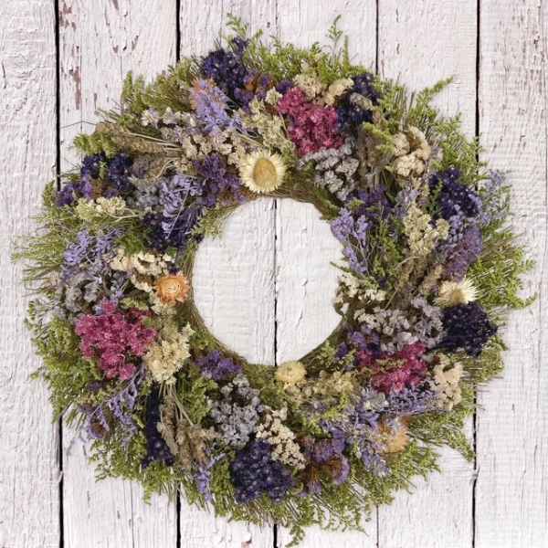 Round floral wreath with purple, pink, and cream dried flowers