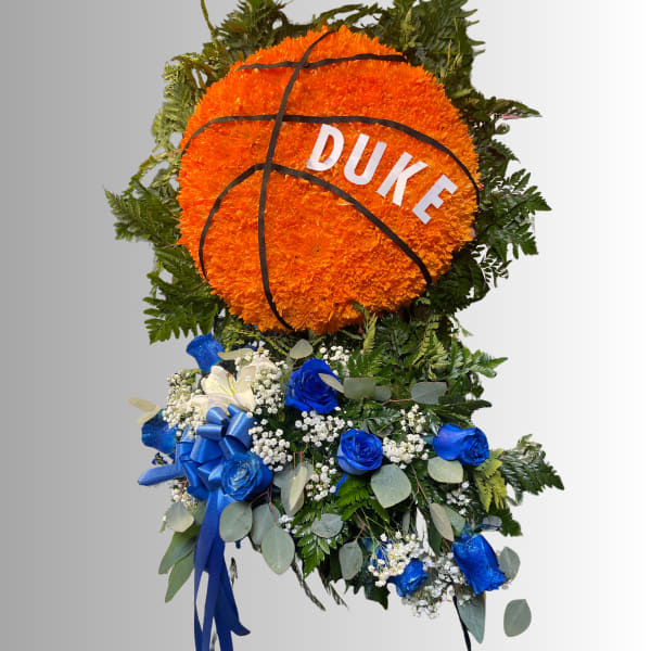 Basketball-shaped floral tribute with orange blooms and blue roses