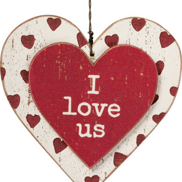 Heart-shaped hanging sign with red hearts and the words I love us