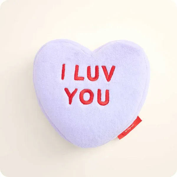 Heart-shaped plush pillow with "I LUV YOU" text