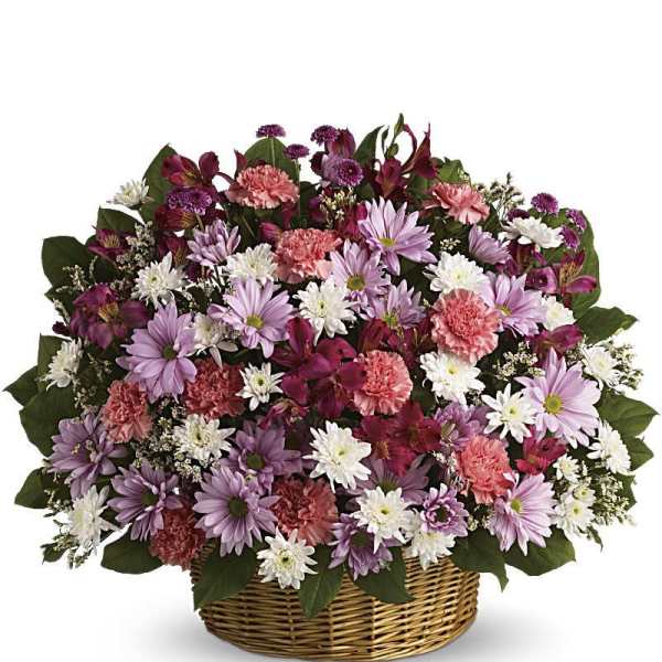 Mixed pink, purple, and white flowers in a wicker basket