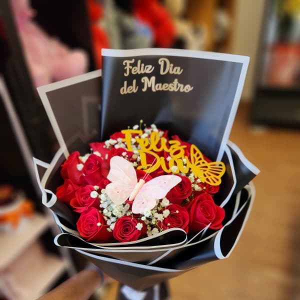 Bouquet of red roses with a butterfly topper and teacher-day card