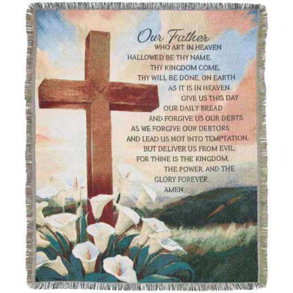 Fringed blanket with a cross, calla lilies, and the Lord's Prayer text