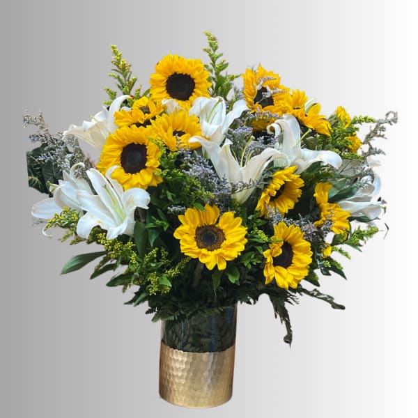 Bouquet of sunflowers and white lilies in a gold vase