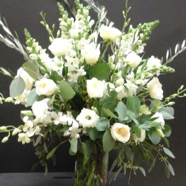 White floral arrangement in a clear glass vase