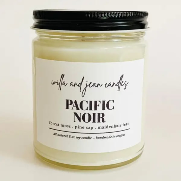 Jar candle with a black lid and white label reading Pacific Noir