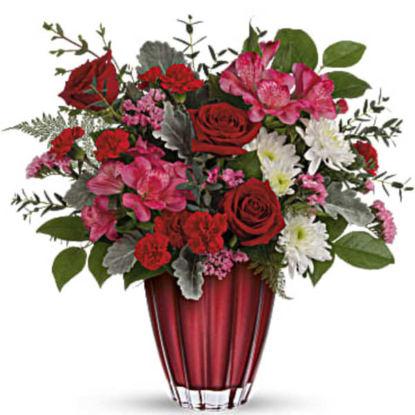 Red and pink mixed bouquet in a red glass vase