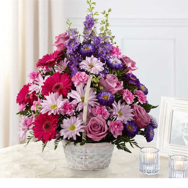 Basket arrangement of pink, purple, and white flowers