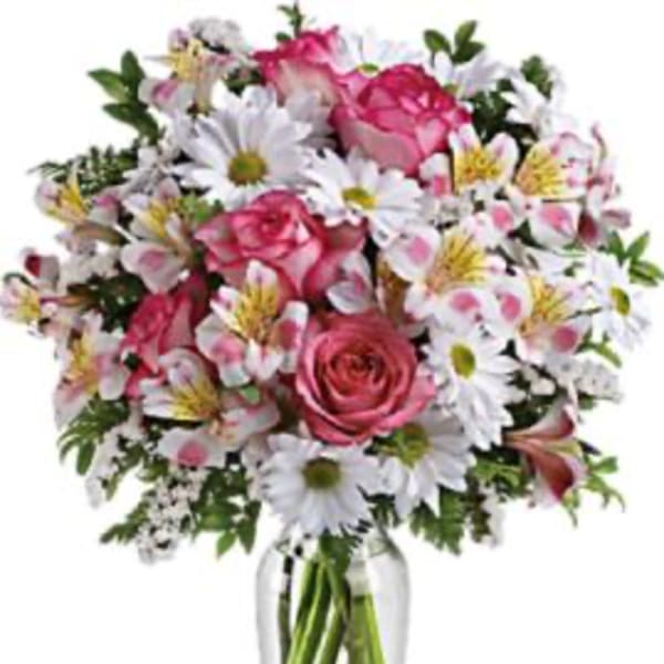 Pink roses and white daisies in a clear glass vase