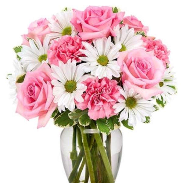 Pink roses and carnations with white daisies in a glass vase