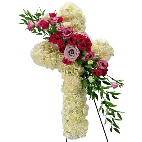 Cross-shaped floral arrangement with pink roses and cream hydrangeas