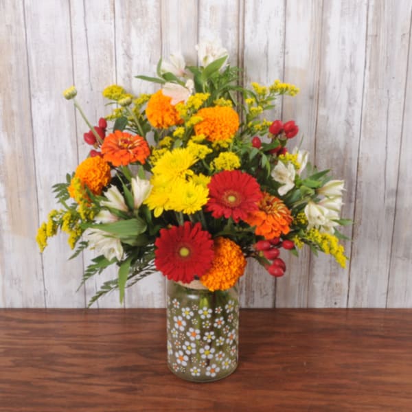 Colorful mixed bouquet in a painted glass vase