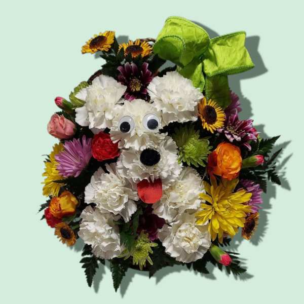 Dog-shaped floral arrangement with a green bow and googly eyes