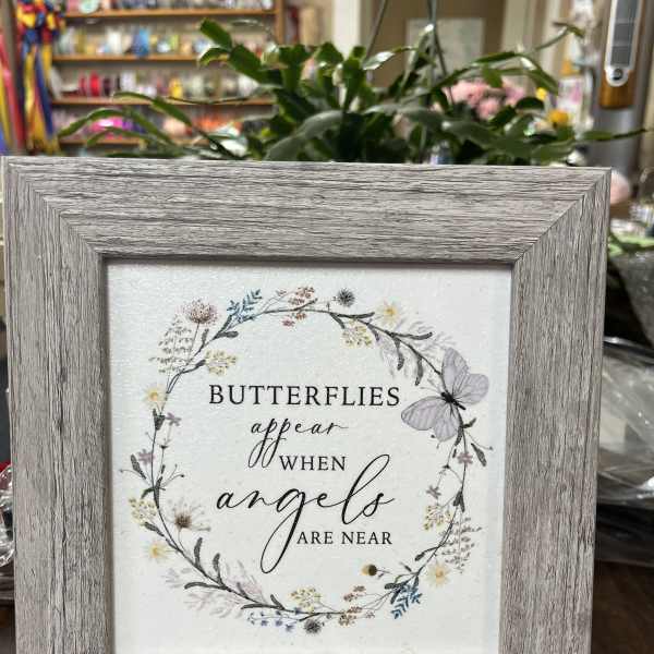 Framed sign with butterflies and the words "butterflies appear when angels are near"