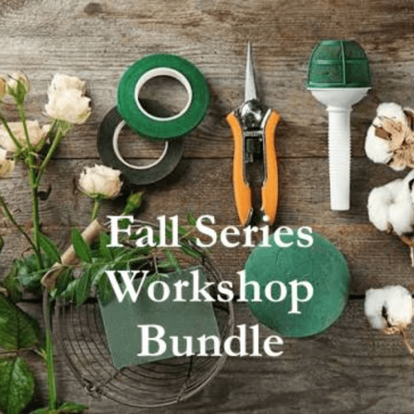 Floral workshop tools and cream roses arranged on a wooden surface