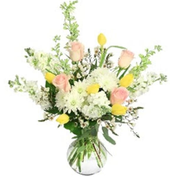 Bouquet of white and pale pink flowers in a glass vase