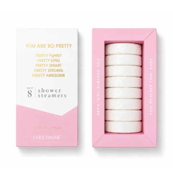 Pink and white box of shower steamers with stacked round tablets