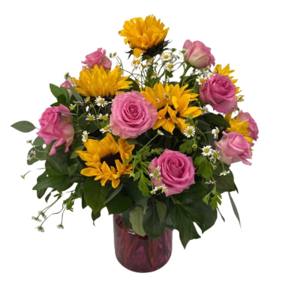 Pink roses and yellow sunflowers in a glass vase