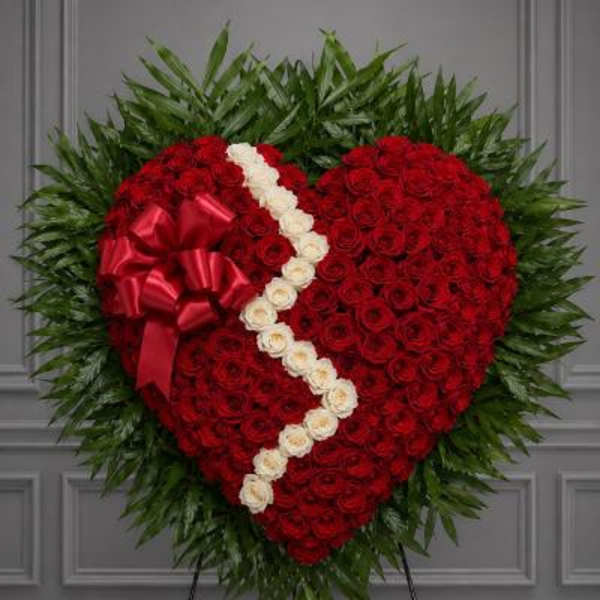 Heart-shaped standing floral tribute with red roses and white roses