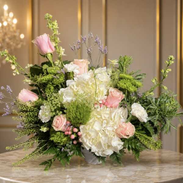 Pink roses and white hydrangeas in a low vase arrangement