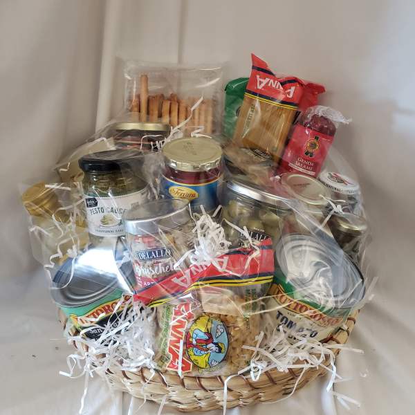 Gift basket with pasta, sauces, olives, and salami