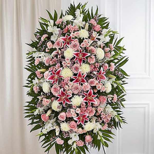 Standing funeral spray with pink and white flowers on an easel