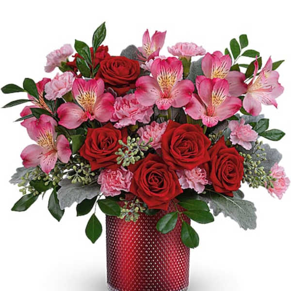 Red roses and pink alstroemeria in a red textured vase