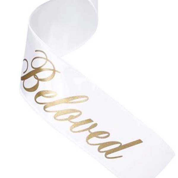 White satin chair sash with gold "Reserved" lettering