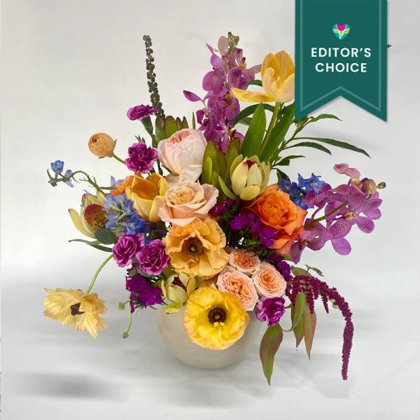 Colorful mixed flower arrangement in a white vase