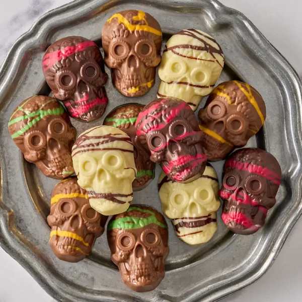 Skull-shaped chocolates on a metal tray
